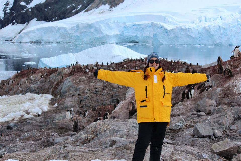 Quark passenger Corina Hitchcock takes in the view in front of a penguin colony in Antarctica.