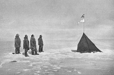 Roald Amundsen, Helmer Hanssen, Sverre Hassel and Oscar Wisting (l–r) at &quot;Polheim&quot;, the tent was upright at the South Pole on 16 December 1911. The top flag is the Flag of Norway; the bottom is marked &quot;Fram&quot;. Photograph by Olav Bjaaland.