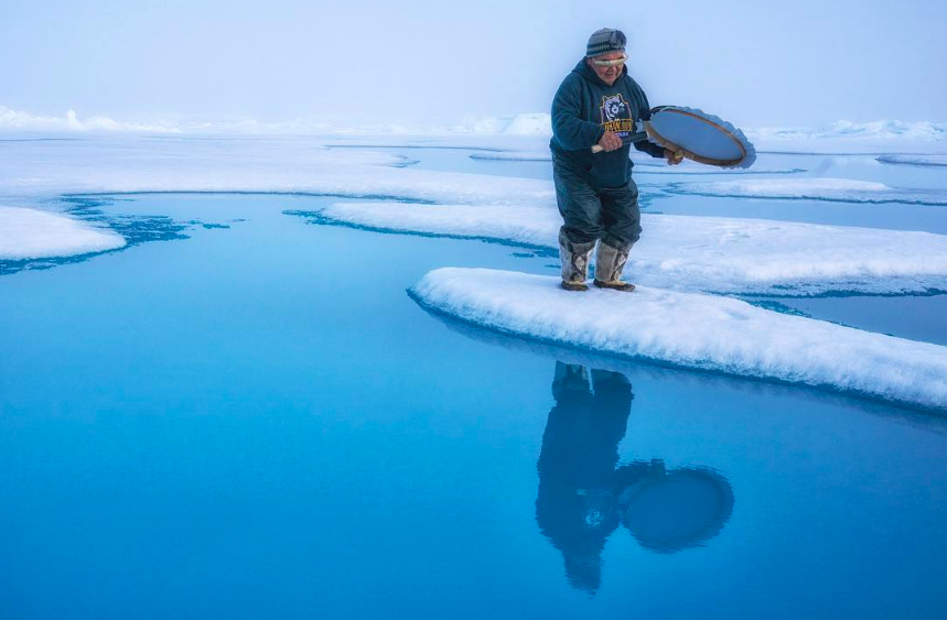 North Pole Summit speaker and Inuit Elder David Serkoak drums on the ice at the North Pole. Photo credit: Cristina Mittermeier