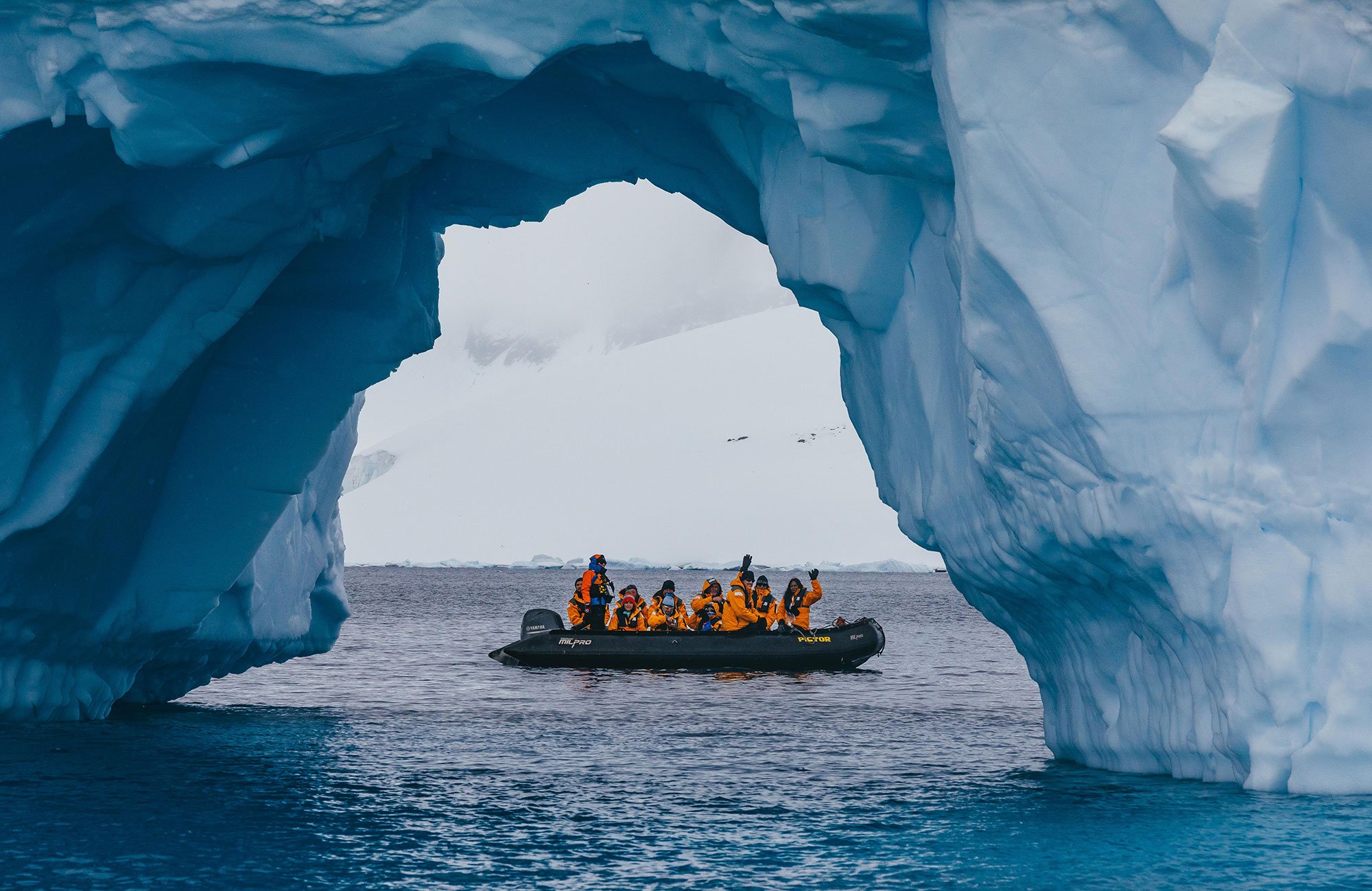 Quark Expeditions guests photograph an iceberg off Cuverville Island. 