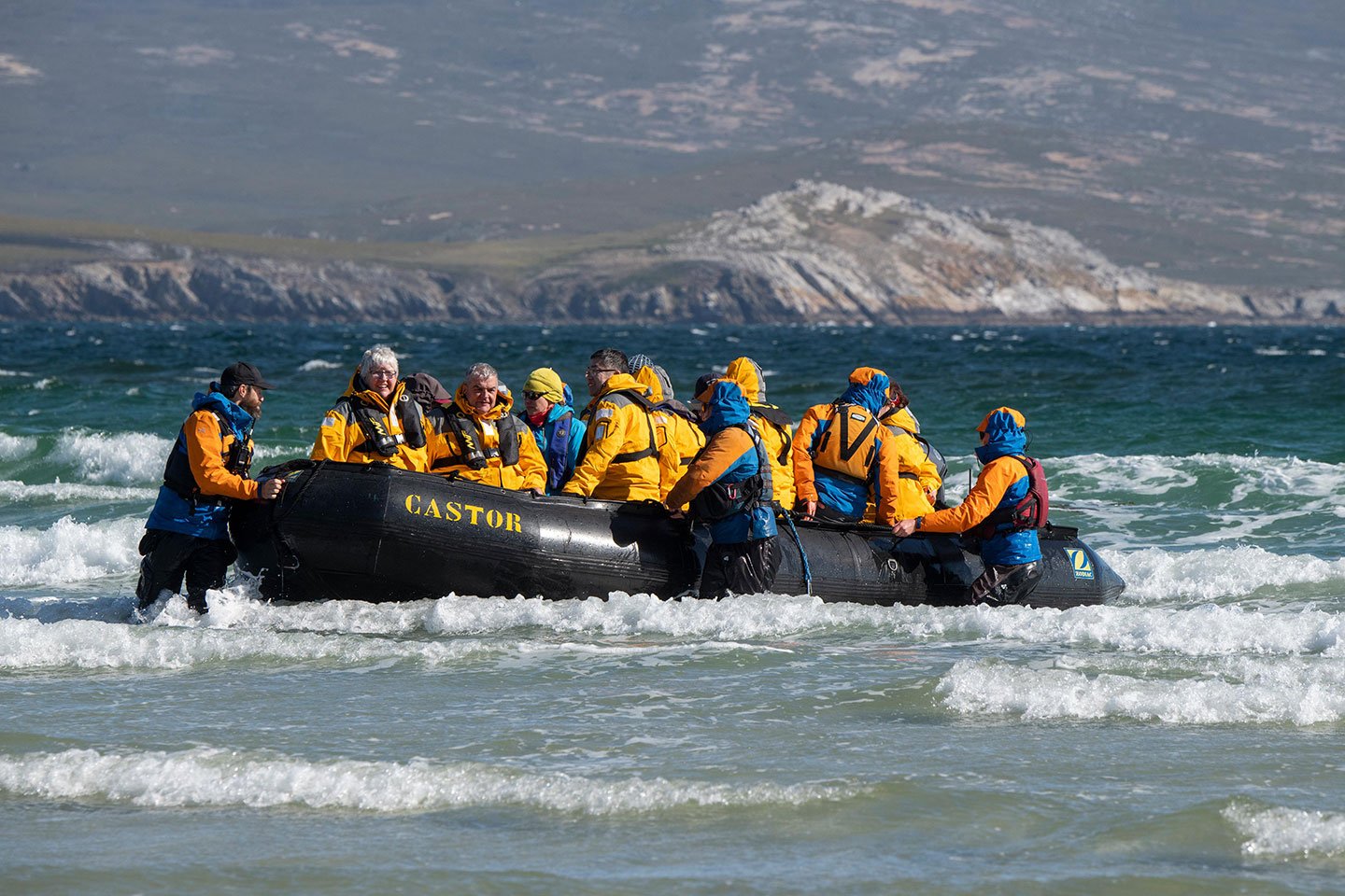 Quark Expeditions guests  on a Zodiac tour approach Saunders Island, Falkland Islands.