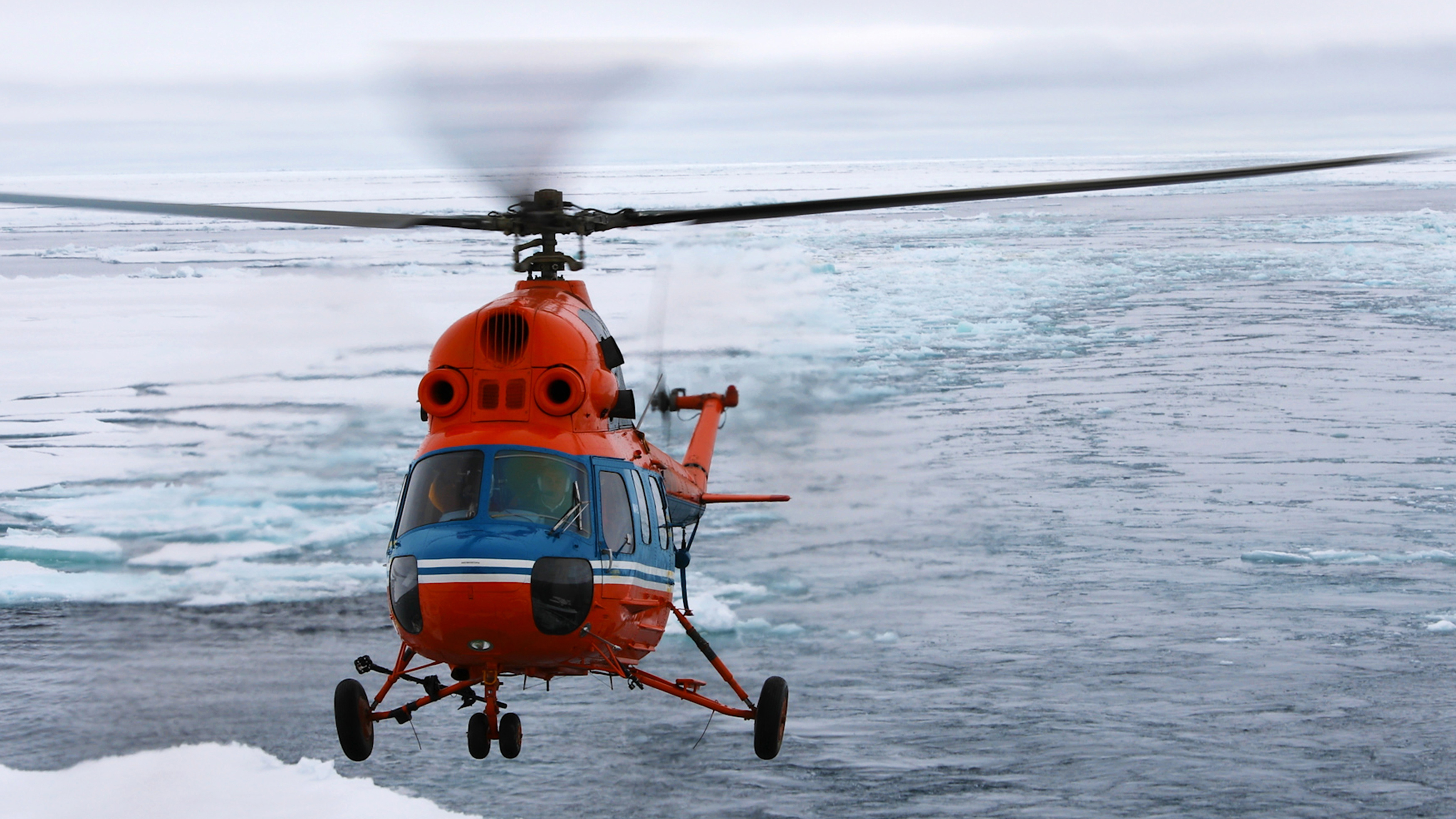 Onboard helicopters allow hydrologists and ice specialists to scout out the conditions ahead, and give passengers a bird’s eye view of the Arctic sea ice from high overhead on sightseeing flights. Photo: Dani Plumb