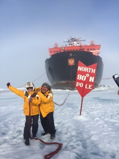 David Serkoak and a fellow North Pole expedition passenger “tow” 50 Years of Victory across the ice at 90° North. Photo credit: David Serkoak