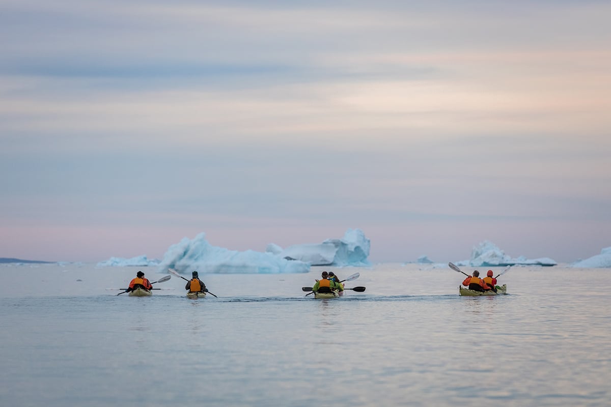 Quark Expeditions guests kayaking in the Arctic, one of the many off-ship activities available on polar voyages.