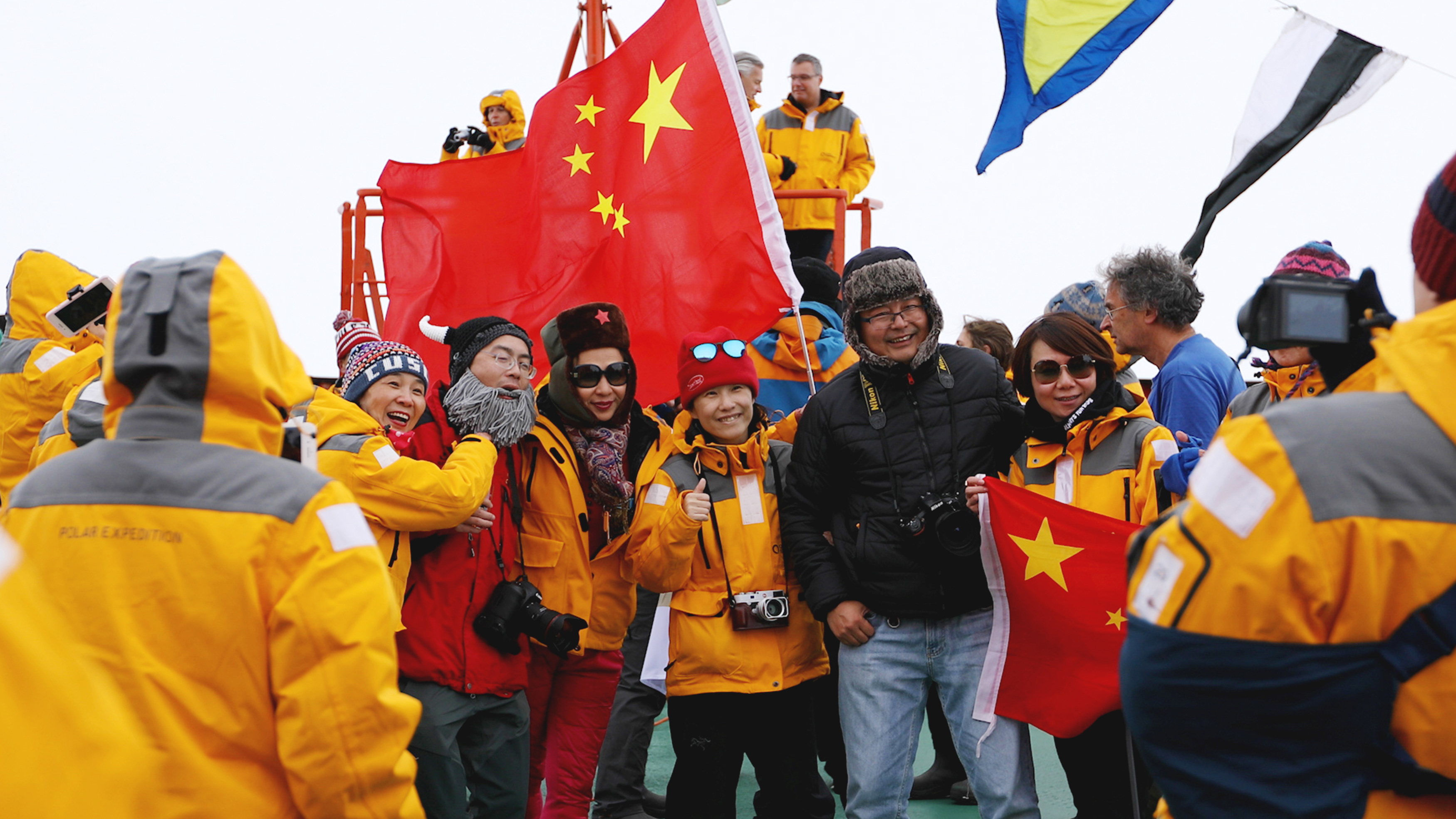 A group of Chinese passengers celebrate reaching the North Pole. Photo: Dani Plumb