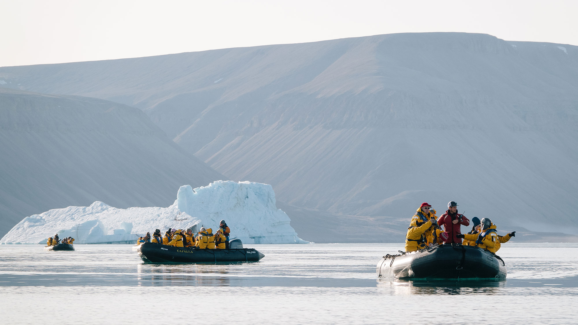 Quark Expeditions guests explore Devon Island during a Zodiac cruise, which is a key element of a polar expedition. 