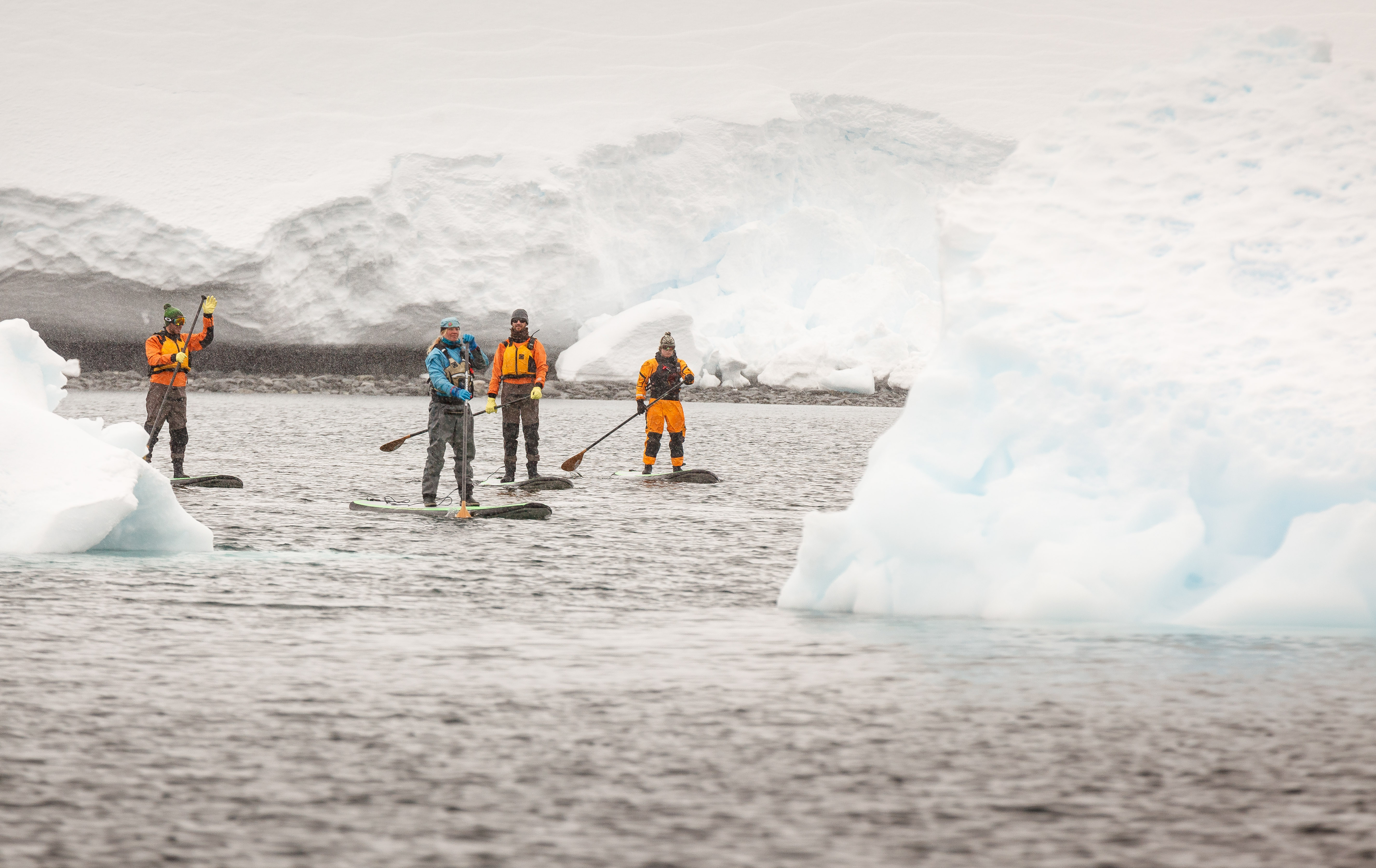 Guided stand-up paddleboarding (SUP) outings let you experience the Arctic or Antarctica from the surface of pristine polar waters.