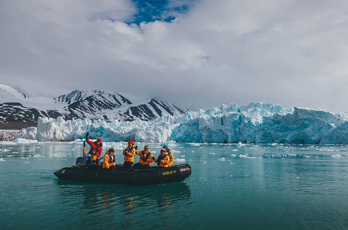 Quark Expeditions guests explore Svalbard during a Zodiac cruise.