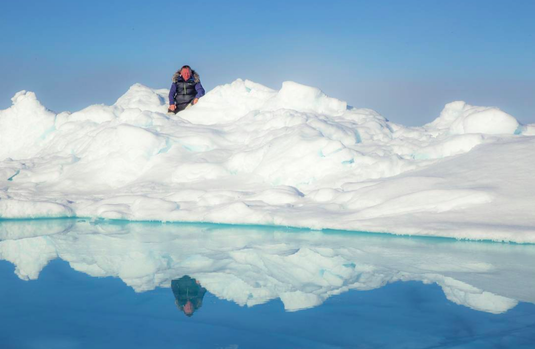 Arctic explorer and motivational speaker Alan Chambers peers over the ice and melt at the North Pole. Photo credit: Tim Kohler