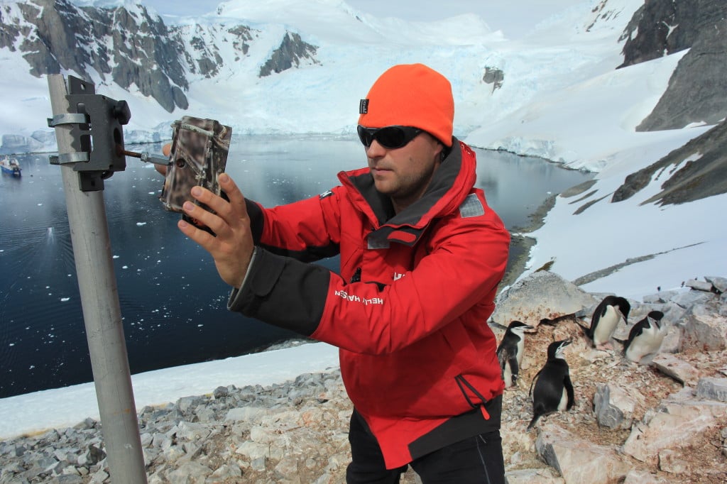 Penguinologist Tom Hart sets up a time lapse camera during a trip to Antarctica.