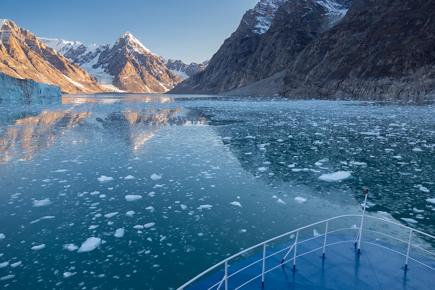A Quark Expeditions ship nears Alpefjord, Northeast East Greenland National Park, the sight of glacier calving.