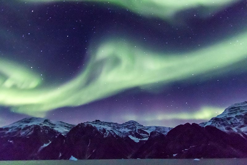 The Aurora Borealis or Northern Lights can be especially vibrant and colorful in Greenland. Photo credit: C King