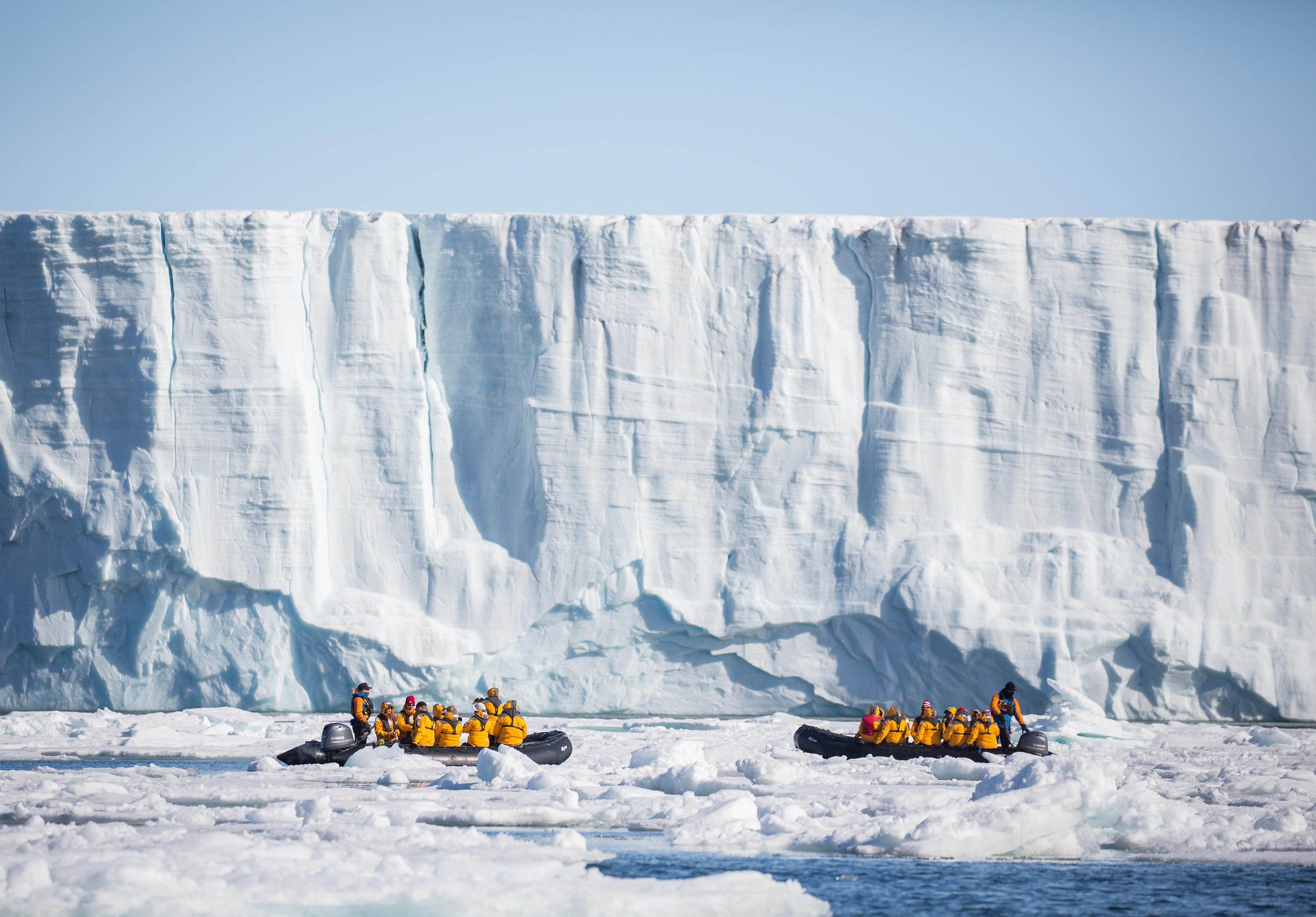 Quark Expeditions guests get a close-up view of a tabular iceberg in Svalbard
