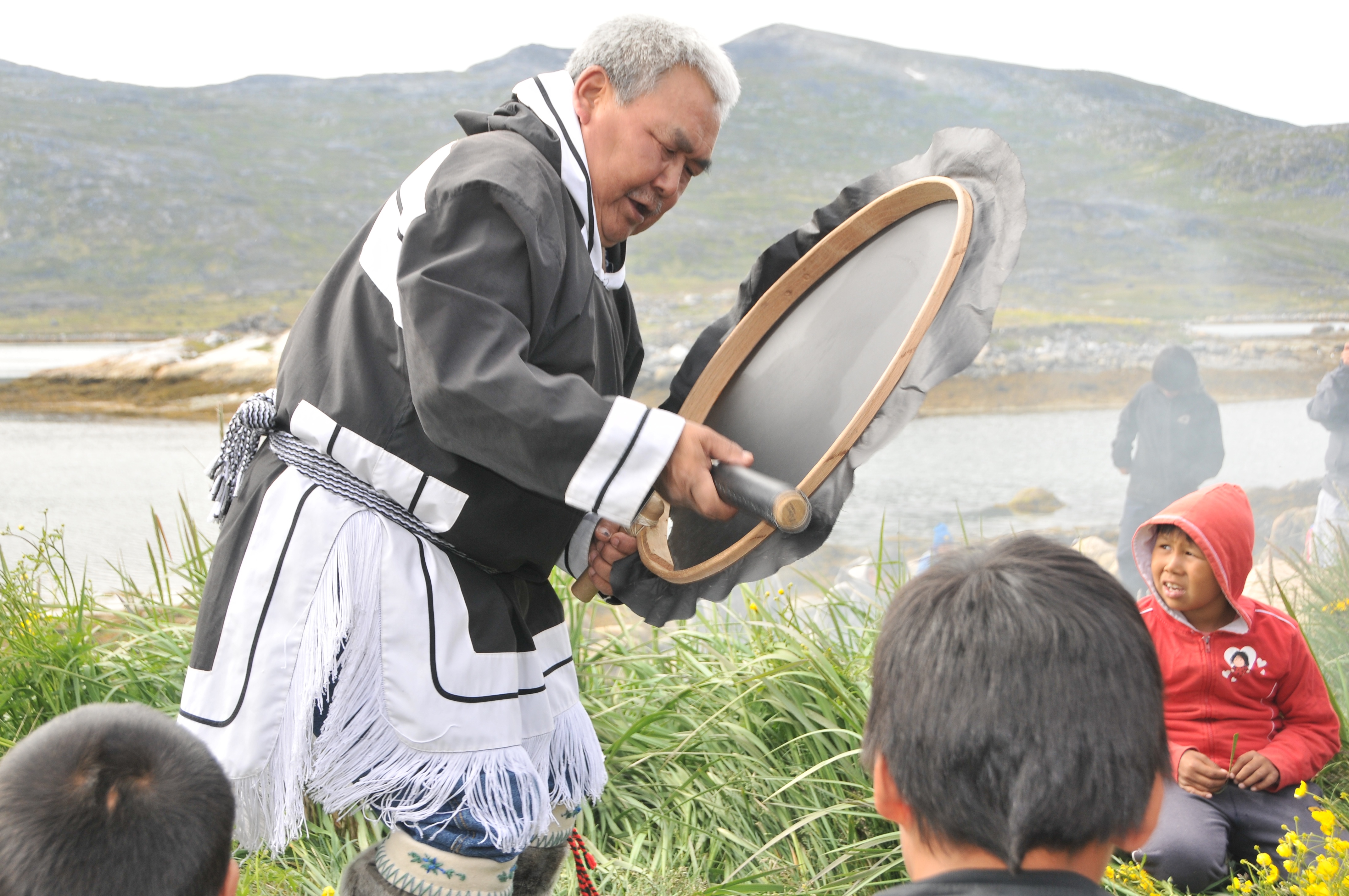 Inuit Elder David Serkoak leads a drum dance in the Arctic.