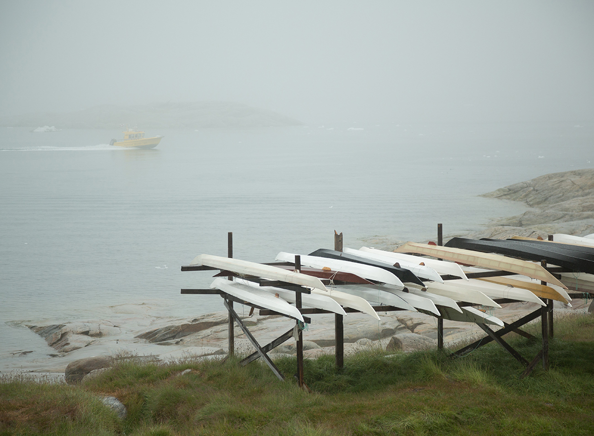 Custom made traditional Greenlandic kayaks sit on top of a rack. Photo by Acacia Johnson