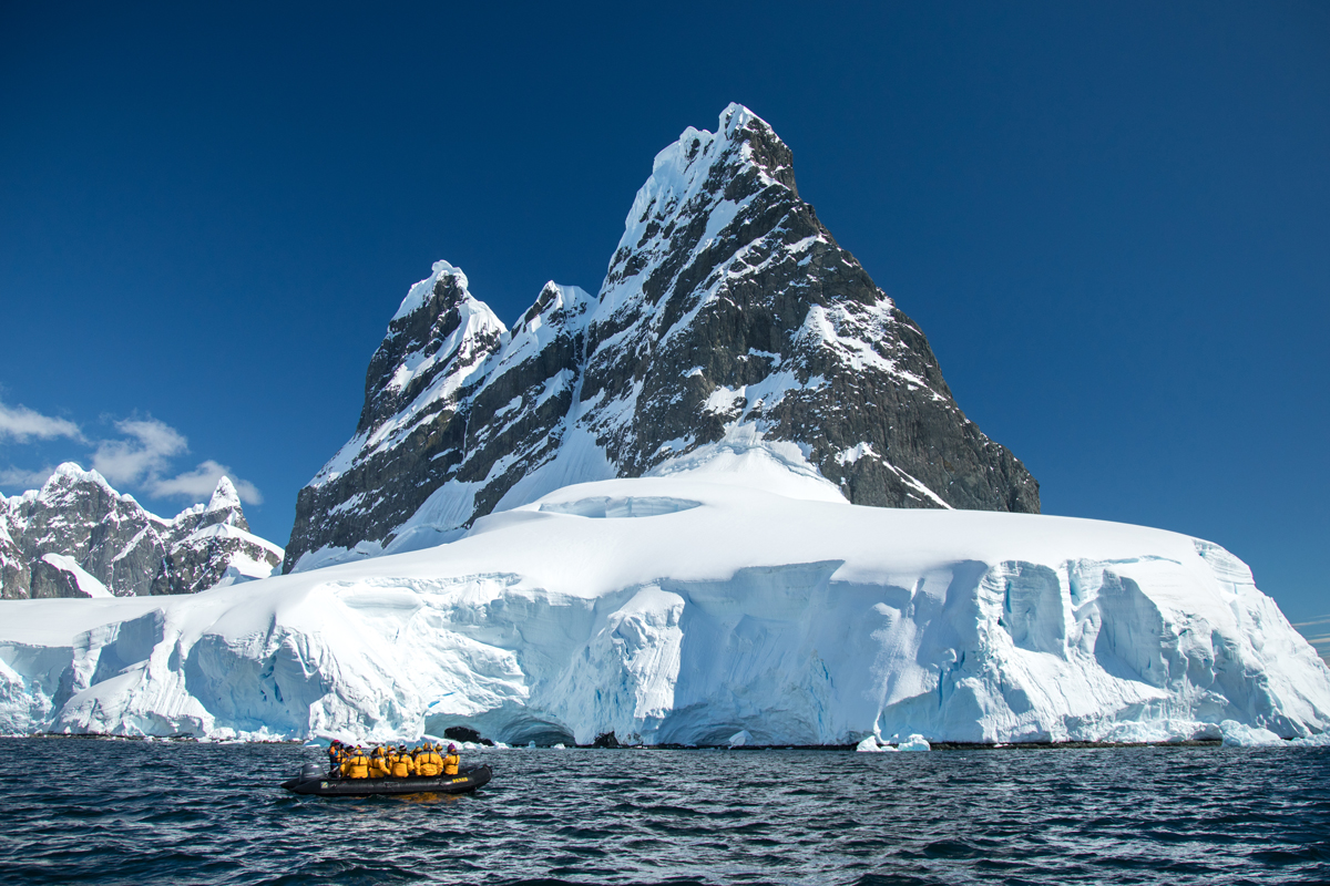 Quark Expeditions ensures guests get off the ship as often as possible during a polar expedition, as evident in this photograph of a Zodiac cruise in the Lemaire Channel, Antarctica.