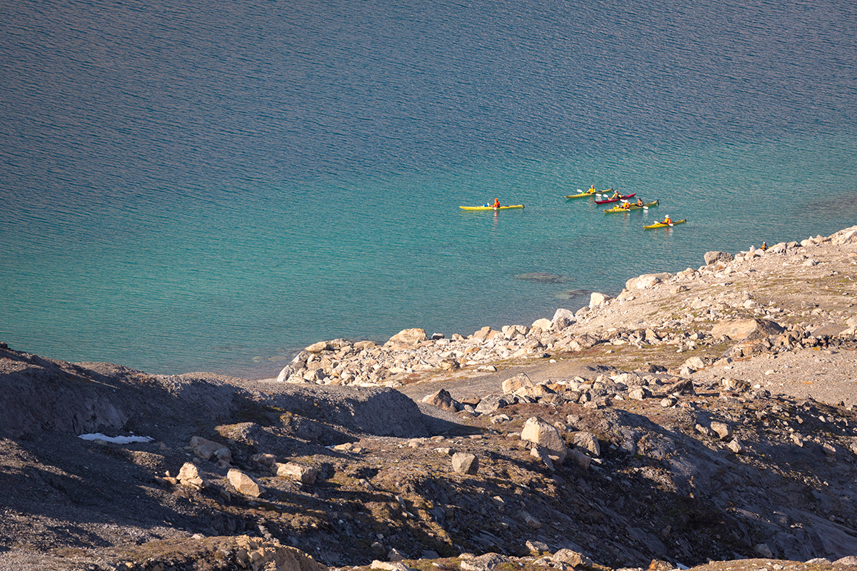  Sea Kayakers traverse the vibrant coast of Skipperdal, East Greenland. Photo by Acacia Johnson