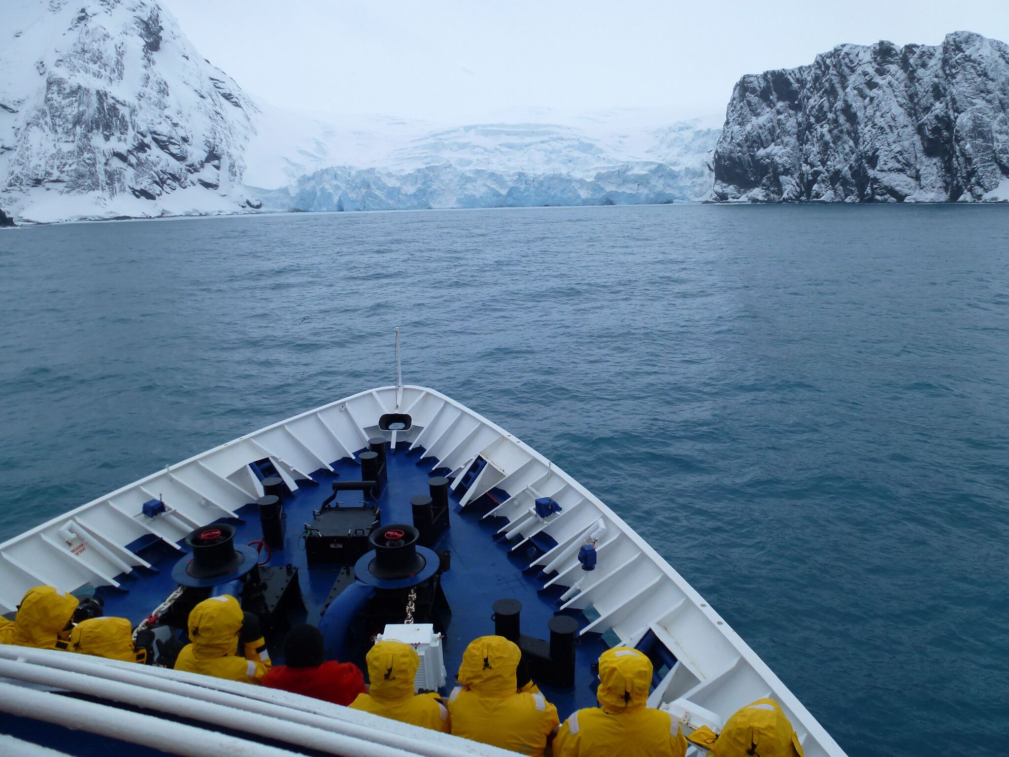 Quark Expeditions guests take in their Antarctic surroundings from the deck of their polar vessel.
