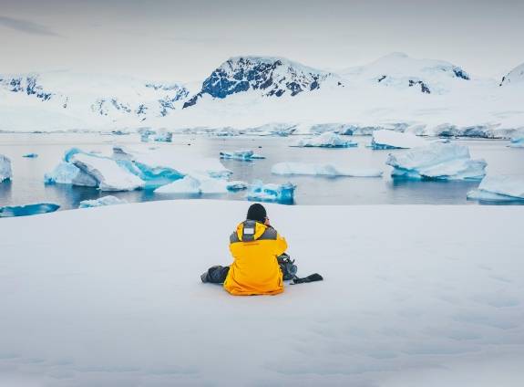 Passenger sitting on Antarctic Landscape