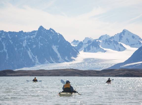Passengers kayaking in Arctic Landscape
