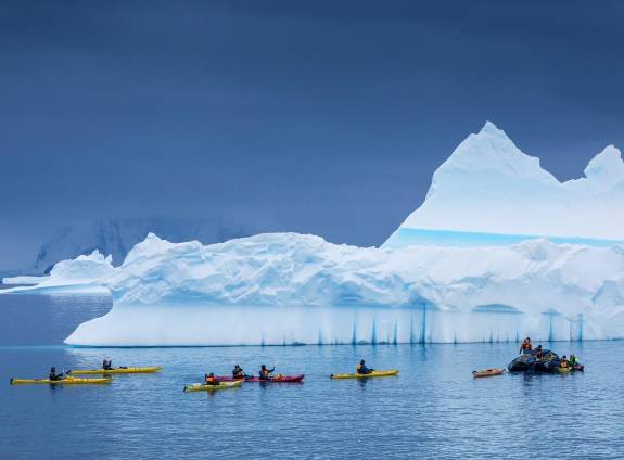 Passengers Kayaking near icy landscape