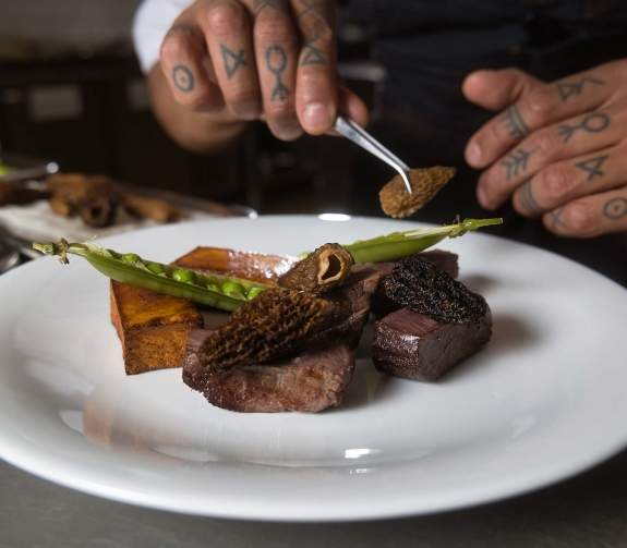 Dry-salted caribou with pommes fondant, morels, peas and banquet sauce