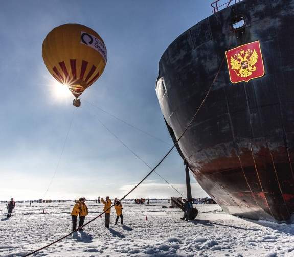 Arctic landscape with passengers, hot air balloon and 50 Years of Victory