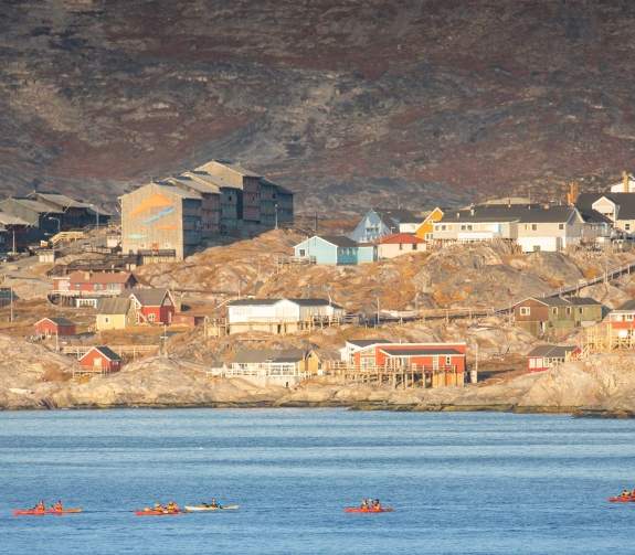 Passengers kayaking in Arctic landscape