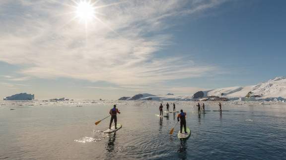 Passengers Stand-up Paddleboarding in the Antarctic